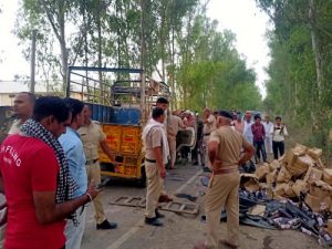 Liquor laden car overturns