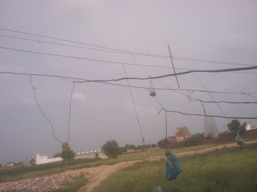 Dangerous high voltage wire hanging from electricity invites death