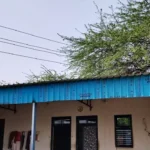 Electricity wires are passing over the roof of the house, posing a threat to the life of the family