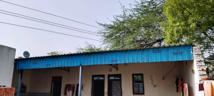 Electricity wires are passing over the roof of the house, posing a threat to the life of the family