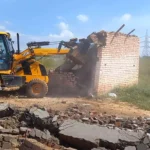 DTP ran a bulldozer on the construction of a colony being developed at three places in Dharuhera