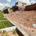 The boundary wall of the subdivision building collapsed during the rains, causing a major accident